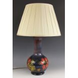 A Moorcroft table lamp in the "Clematis" pattern against a cobalt blue ground, impressed makers