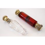 A red glass Victorian scent bottle, the embossed scrolling terminal with red glass faceted body,