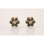 A pair of ‘green’ colour treated diamond and diamond cluster earrings, designed as a flower head