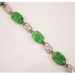 A jade panel bracelet, the five carved jade panels modelled with floral decoration interspersed with