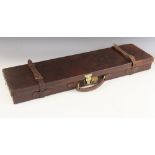 A Holland & Holland leather bound wooden gun case with brass sprung catch and leather over-strap,