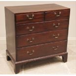 A George III mahogany chest of drawers, formed with two short over three long graduated and oak