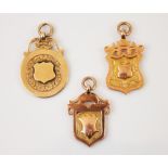 A selection of three 9ct gold fobs, to include a circular example with plain polished central