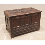 A late 17th/early 18th century oak mule chest, the hinged panelled top over the three panel front