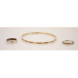 A 9ct gold bangle, the bangle with a continuous cross decoration, marked for ‘JC London’ with a