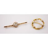 An aquamarine and seed pearl yellow metal bar brooch, the central round cut aquamarine set within an