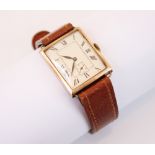 A Mid-20th century 9ct gold wristwatch, the silvered rectangular dial with Roman numerals and