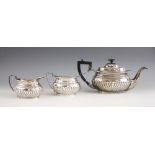 A silver tea service, W A Humphries Ltd, Birmingham 1976, comprising a teapot, milk jug and sugar