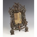 A Victorian copper finished cast iron free-standing picture frame, late 19th century, modelled as