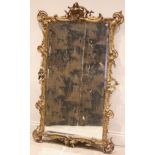 A French rococo gilt wood and gesso pier mirror, late 19th century, with a scrolled foliate and