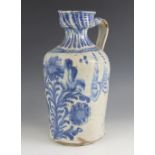 A continental blue and white tin glazed earthenware flagon, 19th century, of typical form with