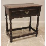 An 18th century oak side table, of cottage proportions, the twin plank top over a single frieze