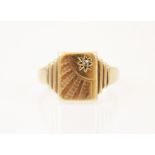 A 9ct yellow gold signet ring, the rectangular shaped head with diamond chip set sun engraved
