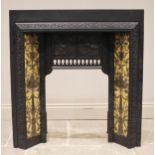 A cast iron tile back fire surround, early 20th century, impressed 'The Salisbury, No.145' to the