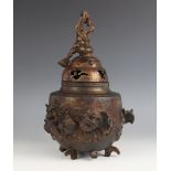 A Chinese parcel gilt and lacquered bronze koro and cover, the cylindrical body applied with