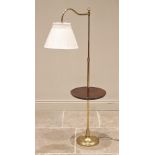 A lacquered brass floor standing reading lamp/table, late 20th century, the adjustable arm upon an