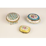 A selection of three enamelled pill boxes, to include a Limoges oval example, florally decorated