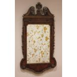 A George I style walnut veneered wall mirror, 20th century, the twin swan neck gilt composite