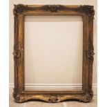 A 19th century gilt wood and gesso picture frame, cast in relief with shells and reeded detail,