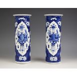 A pair of Chinese porcelain blue and white sleeve vases, 19th century, each of cylindrical form