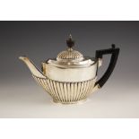 An Edwardian silver teapot, Mappin Brothers, Sheffield 1900, the composite finial above a reeded