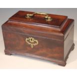 A George III flame mahogany tea caddy, of sarcophagus form, the hinge cover applied with brass