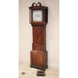 A late George III oak cased longcase clock signed 'Moses Evans, Llangernew', the twin swan neck hood