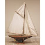 A varnished wooden pond yacht of large proportions, the early 20th century hull with lead keel,
