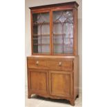 A Regency mahogany secretaire bookcase, the ogee beaded astragal glazed doors opening to three