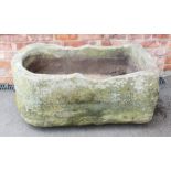 A 19th century bow fronted sandstone pump trough, with drain hole to one side, 40cm H x 109cm W x