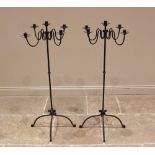 A pair of wrought iron freestanding candelabra, 20th century, each with four 'S' shaped arms upon