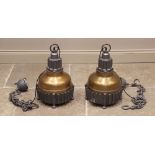 A pair of cast metal industrial type ceiling lights, of bell form with a painted domed shade,