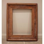 A carved hardwood frame, 20th century, the rectangular frame moulded with nulled, ribbon twist and
