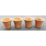 A set of four terracotta planters, of inverted ribbed bell form, 37cm H x 42cm D (4)