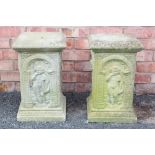 A pair of reconstituted stone garden pedestals, each of square section, cast in relief with