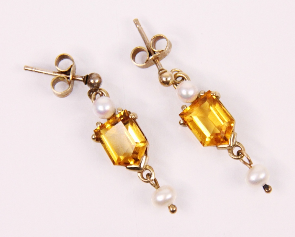 A pair of citrine and pearl earrings, the pearl suspending fancy cut citrine and further pearl, claw