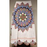An early 20th century quilt, with central radiating circular medallion in pink, blue and green,