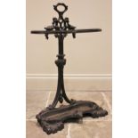 A Coalbrookdale style cast iron stick stand, the pierced and intertwined upright supporting a pair