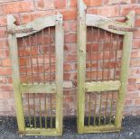 A pair of hardwood and wrought iron gates, applied with iron ring hinges, each gate measures,