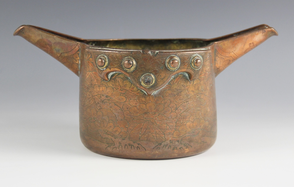 A Chinese copper cooking vessel, 18th/19th century, the tapered cylindrical body with twin spouts,