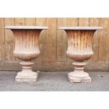 A pair of Victorian cast iron garden campana urns, of typical fluted form, 48cm H x 42cm D