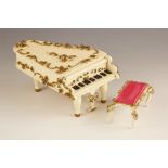 A Swiss music box by Reuge, modelled as a grand piano with scroll and foliate embellishments,