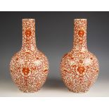 A pair of Chinese porcelain iron-red bottle vases, 20th century, each vase with a craquelure body