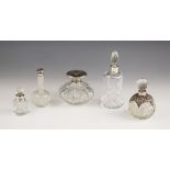 A selection of silver mounted scent bottles, including a Moody & Archer, Birmingham 1975, the pull-