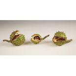 Three Penkridge Ceramics horse chestnut tree seed pods, each modelled slightly open with conkers