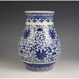 A Chinese porcelain blue and white lotus vase, Qianlong mark, the vase of shallow baluster form