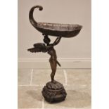 A bronze floor standing jardinere stand, 20th century, modelled as Cupid arms aloft holding a boat