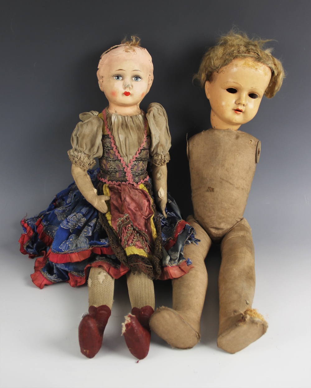 A collection of antique dolls and doll parts, comprising: a papier-mache shoulder head doll, 19th