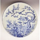 A large Japanese Arita porcelain blue and white charger, Meiji period (1868-1912), of circular