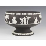 A Wedgwood black basalt footed bowl, mid 20th century, the body with white jasper bas relief